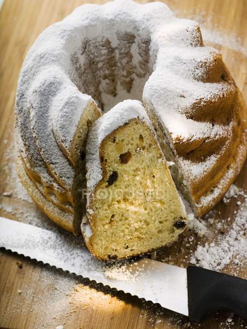 Closeup view of cut Gugelhupf with icing sugar — Stock Photo