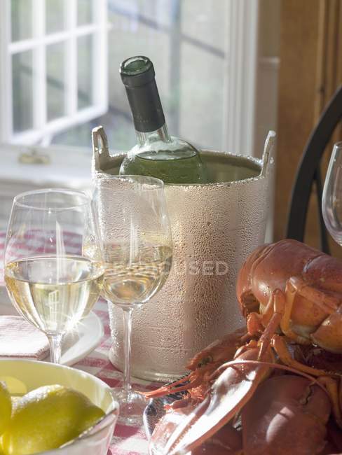 White wine bottle in ice bucket — Stock Photo