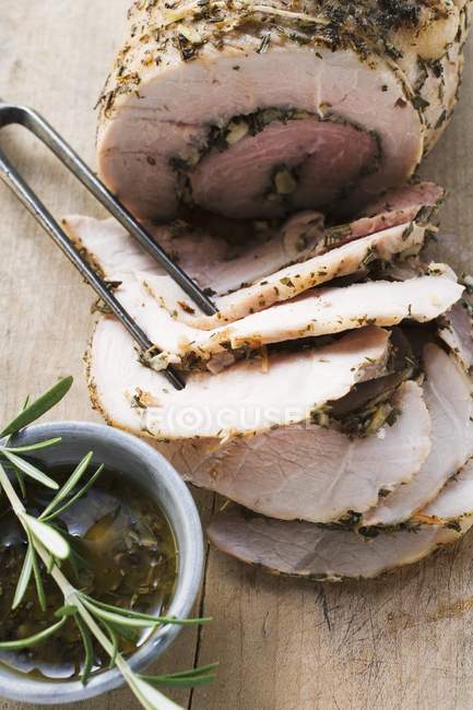 Rolled pork roasted with herbs — Stock Photo