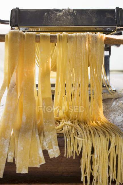 Ribbon pasta in pasta maker — Stock Photo