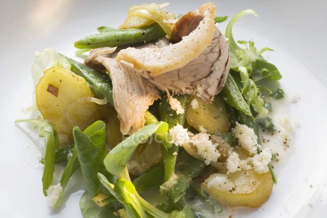 Salad leaves with potatoes and pork — Stock Photo