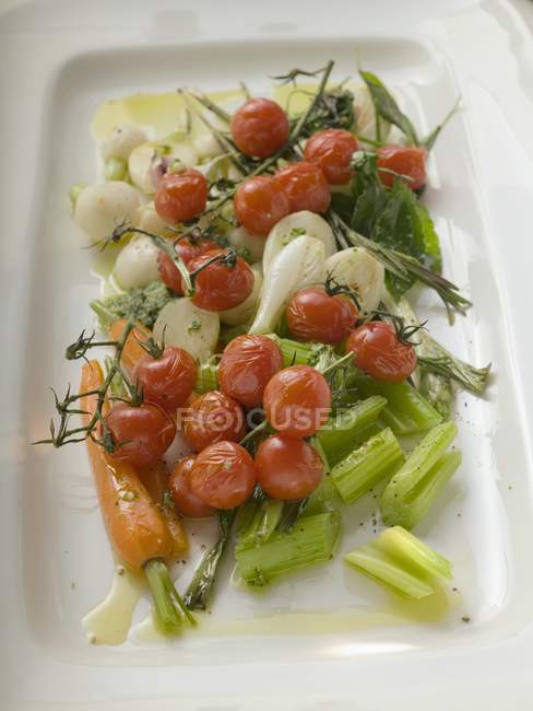 Roasted cherry tomatoes with celery — Stock Photo