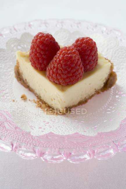 Piece of cheesecake with raspberries — Stock Photo