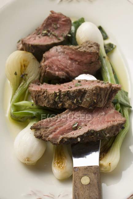 Steak de boeuf aux oignons de printemps rôtis — Photo de stock