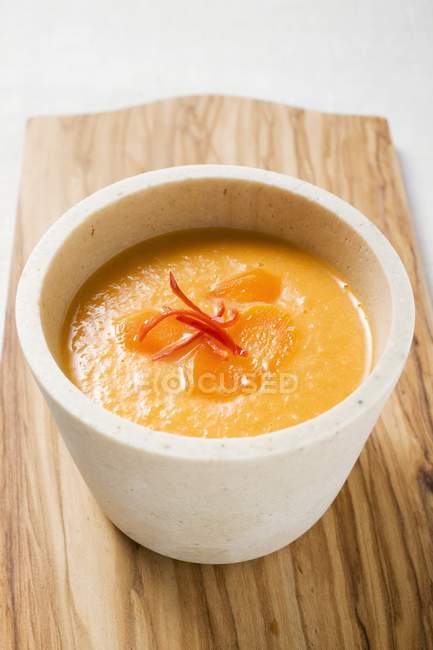Carrot soup with chili pepper in pot — Stock Photo