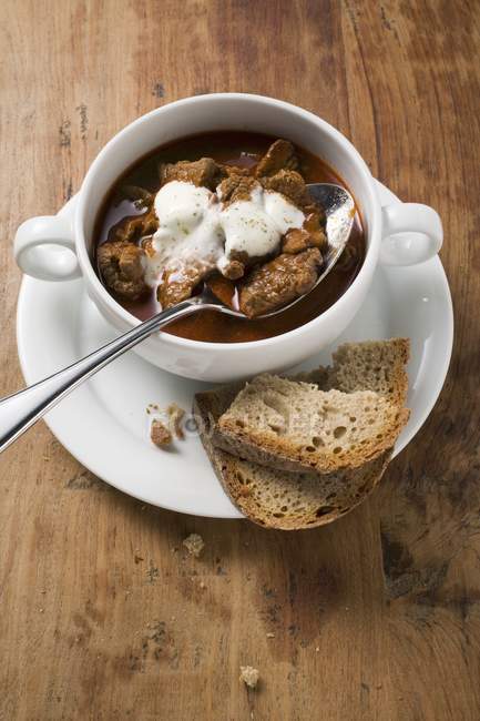 Goulash soup with sour cream — Stock Photo