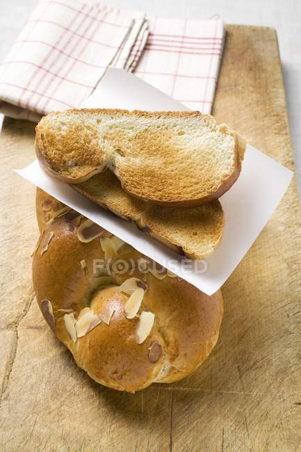 Partly sliced with toasted slices on loaf — Stock Photo