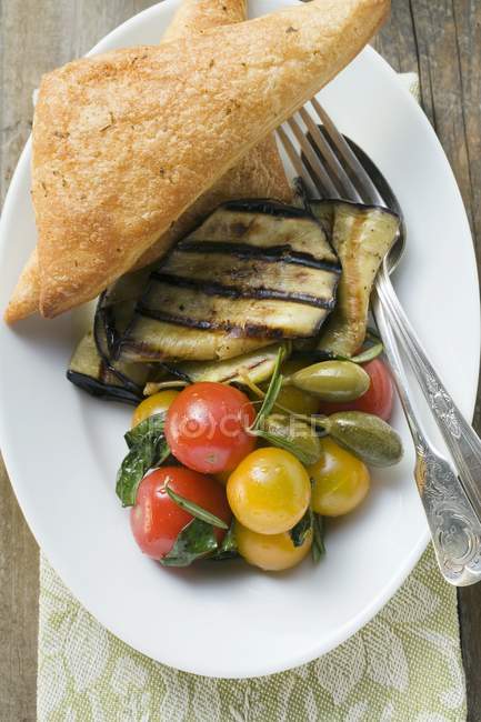 Grilled aubergines with cherry tomatoes — Stock Photo