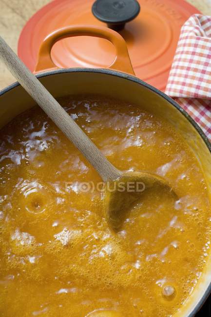 Jam in pan over table — Stock Photo