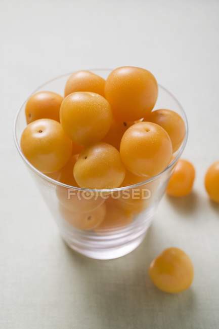 Mirabelles in and beside  bowl — Stock Photo