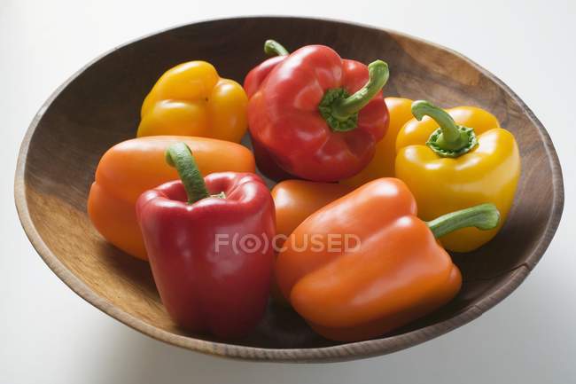 Peppers in wooden bowl — Stock Photo