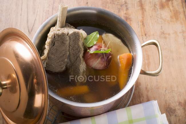 Broth with beef and soup vegetables — Stock Photo