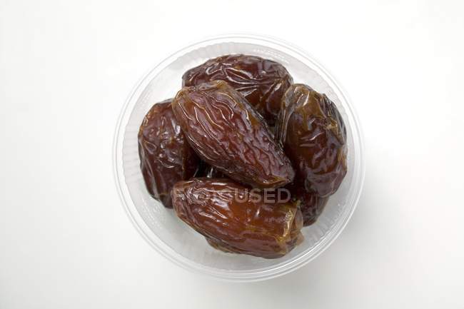Dried dates in plastic dish — Stock Photo