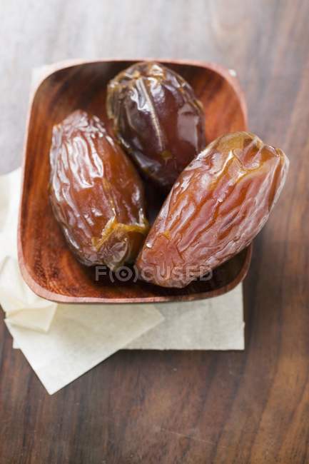 Dried dates in wooden bowl — Stock Photo