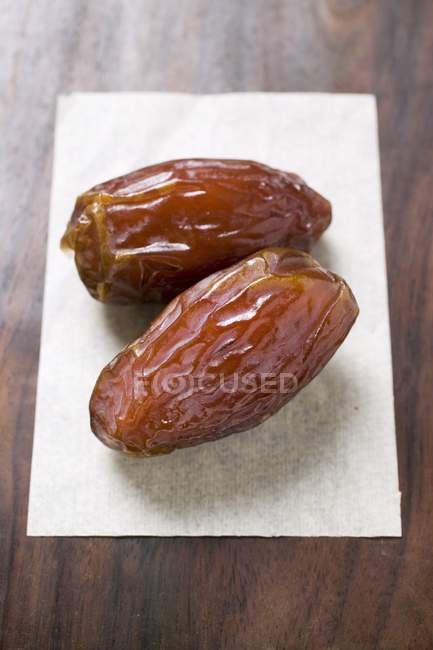 Dried dates on paper — Stock Photo