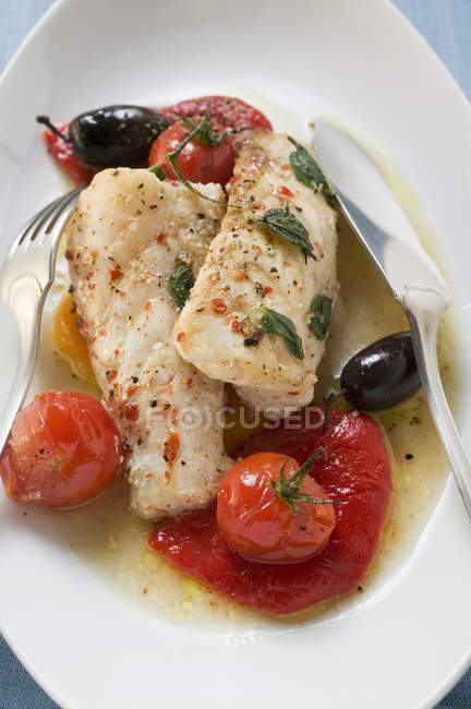 Monk-fish fillets with cherry tomatoes and olives — Stock Photo