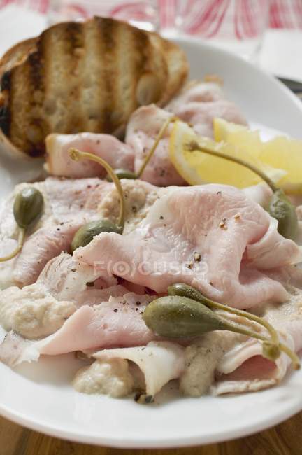 Cold roast pork with capers — Stock Photo