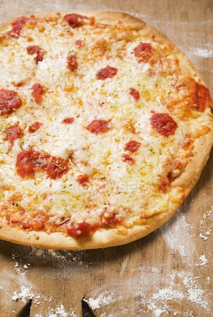 Pizza on wooden board — Stock Photo