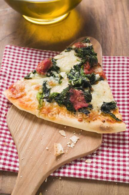 Pizza with slice on server — Stock Photo