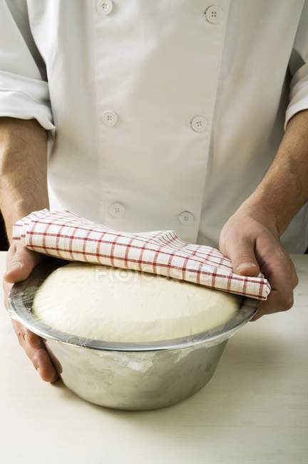 Chef holding pizza dough — Stock Photo
