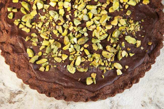 Closeup top view of chocolate shortbread with pistachios and ganache — Stock Photo