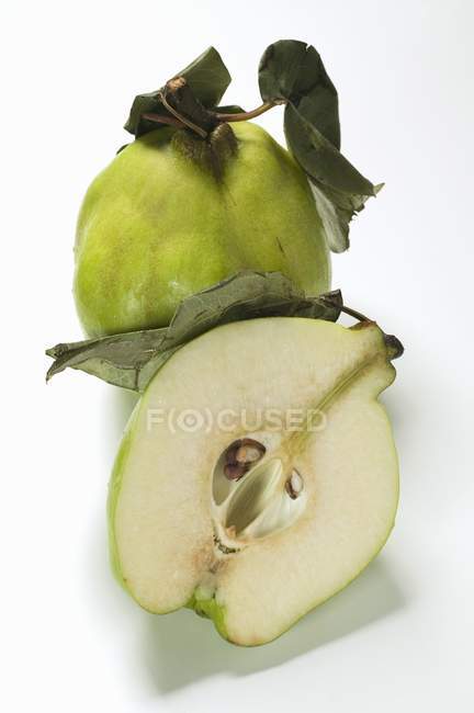Whole fresh quince with half — Stock Photo