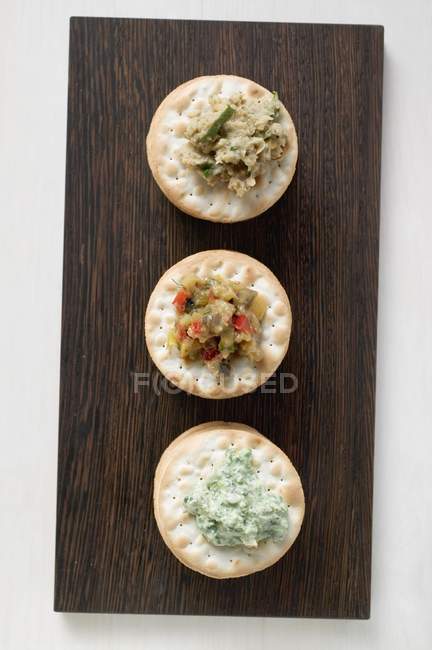 Crackers with different spreads — Stock Photo