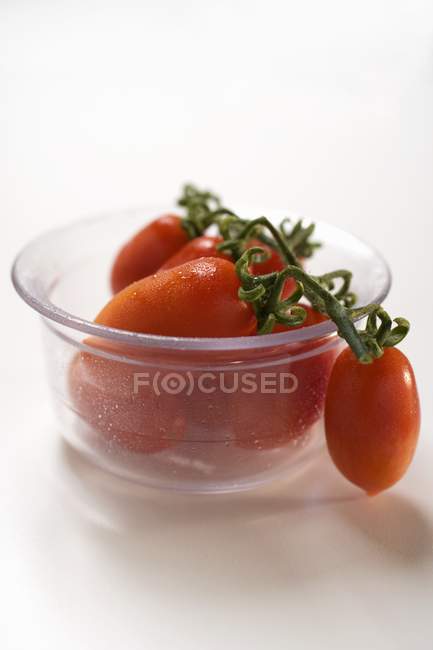 Plum tomatoes in glass bowl — Stock Photo