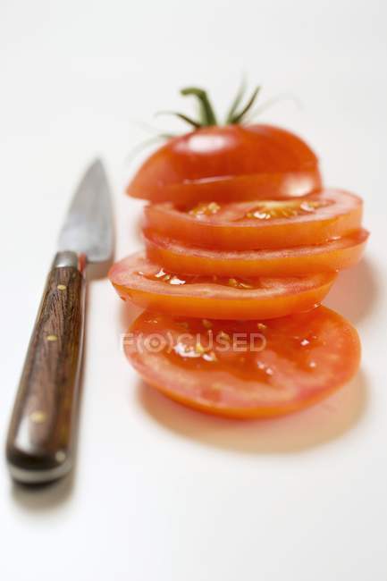 Tomato sliced and knife — Stock Photo