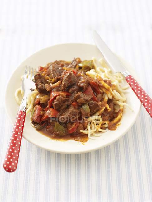 Goulash with peppers and spaetzle — Stock Photo