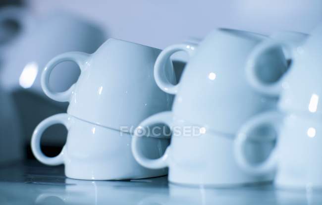 Closeup view of white upturned cups piles — Stock Photo