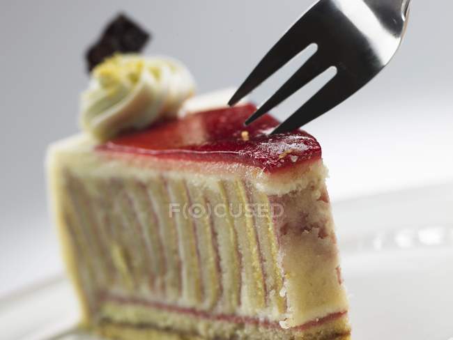 Raspberry marzipan cake with cake fork — Stock Photo
