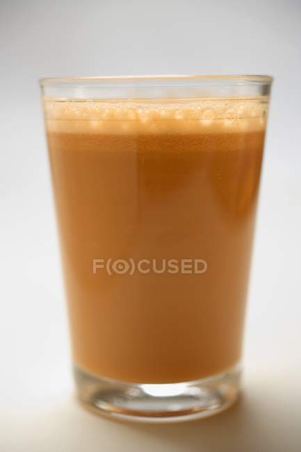 Fresh carrot juice served in glass — Stock Photo
