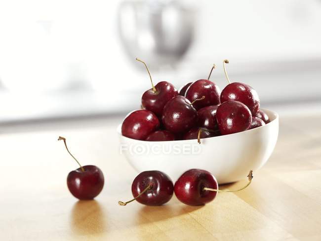 Cherries in white bowl — Stock Photo
