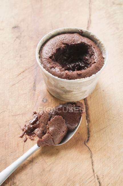 Closeup view of small chocolate souffle filled with chocolate sauce — Stock Photo