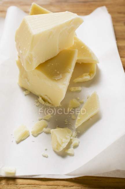 Closeup view of white chocolate pieces on paper — Stock Photo