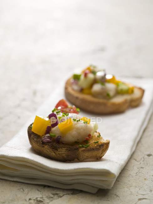 Ceviche on toasted baguette — Stock Photo