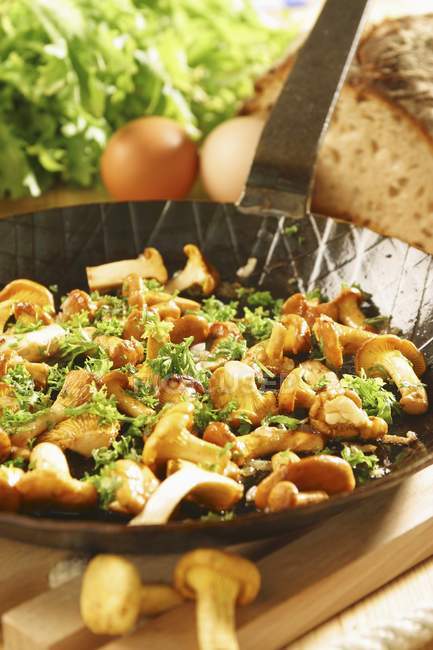 Closeup view of fried chanterelles in frying pan — Stock Photo