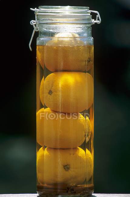 Closeup view of homemade orange liqueur in jar — Stock Photo