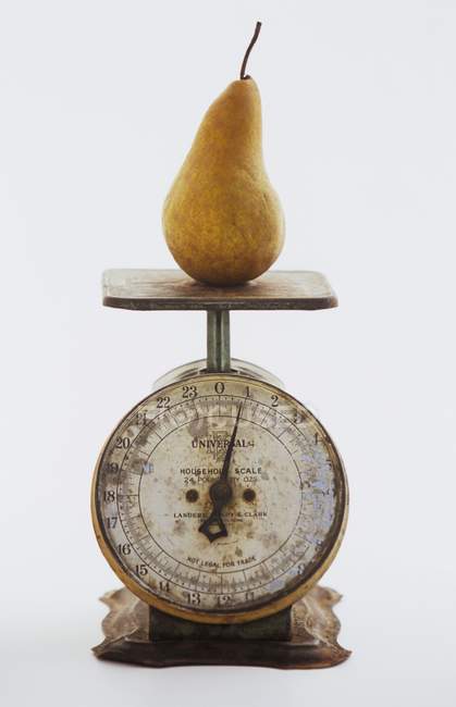 Pear on Metal Scale — Stock Photo