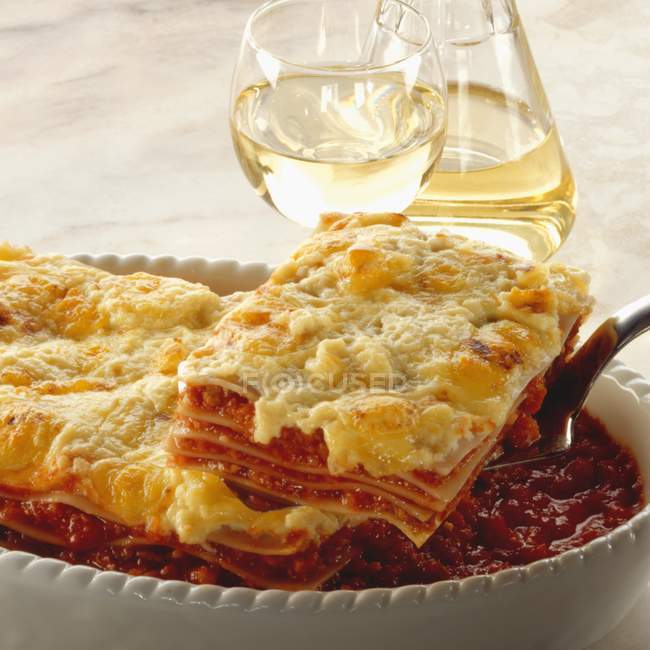 Portion of tomato lasagne on spatula — Stock Photo