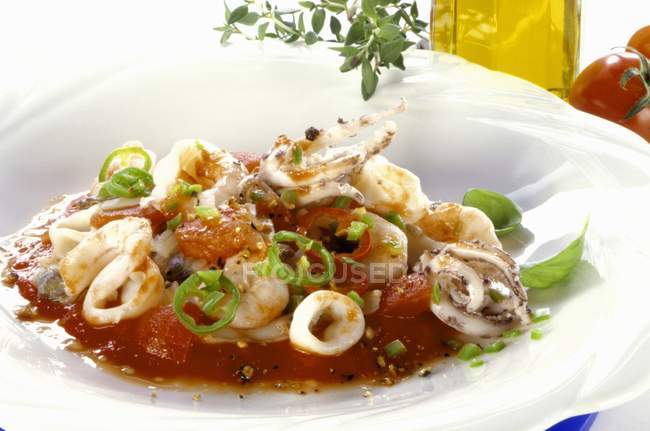 Squid in tomato sauce — Stock Photo