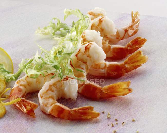 Cooked shrimp tails and frise — Stock Photo