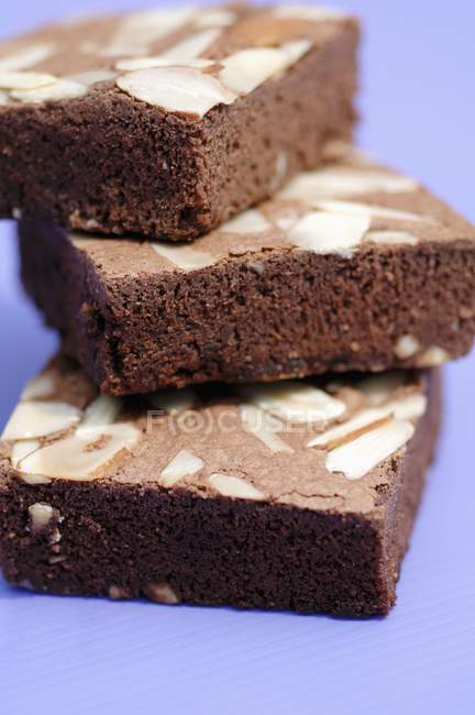 Brownies with almonds stacked in pile — Stock Photo
