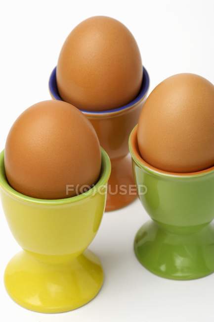 Three eggs in eggcups — Stock Photo