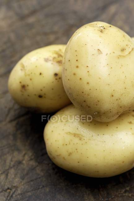 Three raw and washed potatoes — Stock Photo