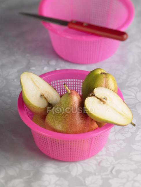 Pears in pink strainer — Stock Photo