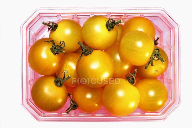 Yellow cherry tomatoes in plastic punnet — Stock Photo