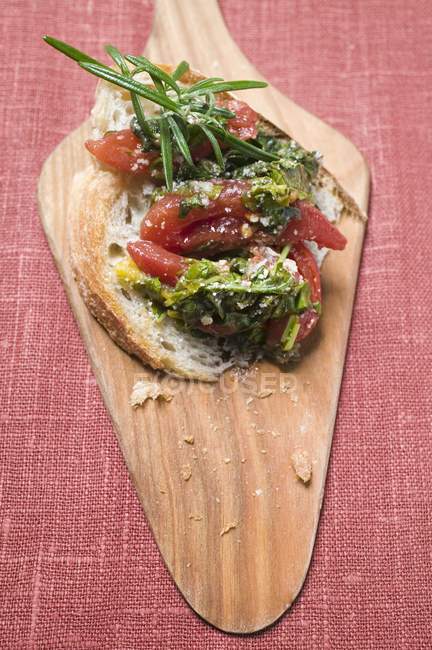 Chard and tomatoes on bread — Stock Photo