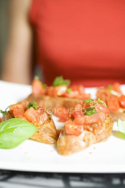Bruschetta with tomatoes and fresh basil — Stock Photo